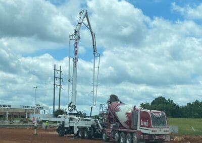 Pump It Up Concrete crane and cement truck on worksite