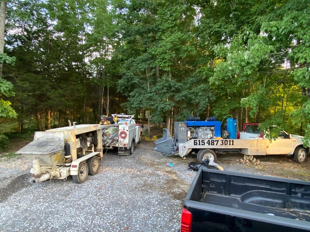 picture of trucks and equipment parked at a work site