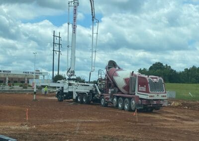 Pump It Up Concrete boom pump pouring footers at a townhouse construction site