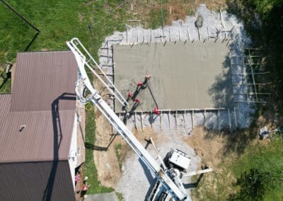 Boom pump in use by Pump It Up Concrete for pouring concrete on workshop slab